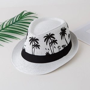 Detail of white straw fedora featuring black palm tree prints and a stylish black band