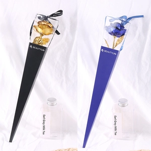 Detail of 24k gold foil artificial roses in elegant black and blue gift boxes