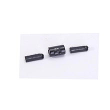 Detail shot of three black industrial plastic connectors and cylinder components