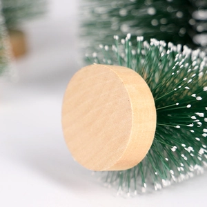 Mini green pine needle Christmas tree with white snow tip and wooden base