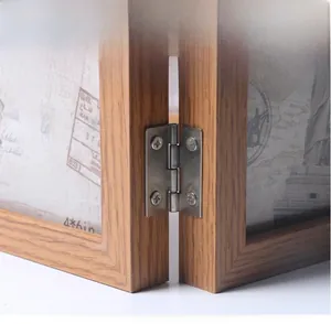 Detail of metal hinge on vintage double wooden picture frame with manual polishing