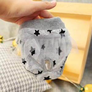 Close-up of star print dog sanitary pants with lace trim and tail hole detail