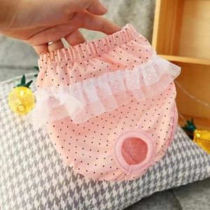 Detail of pink polka dot cotton dog diaper with lace trim and elastic waist for small pets