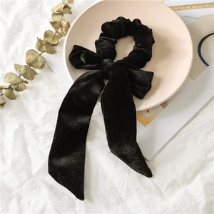 Macro shot of high-quality black velvet oversized scrunchie with long elegant streamers