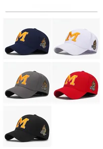Detail of five colored baseball caps featuring embroidered M and Tiger patch designs
