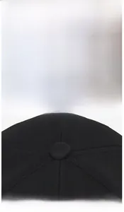 Detail of gothic B embroidery and stitched panel seams on black stretch baseball cap