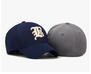 Close-up of navy and grey baseball caps featuring 3D Gothic B embroidery detail