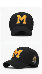Detail of black cap with orange 3D embroidered M and side tiger head stitching