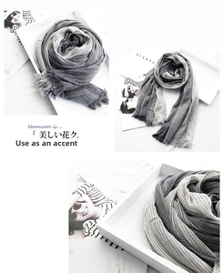 Macro shot of grey and white gradient stripe scarf with natural frayed edge detail