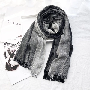 Japanese style black and gray striped scarf with fringe on a white fabric background