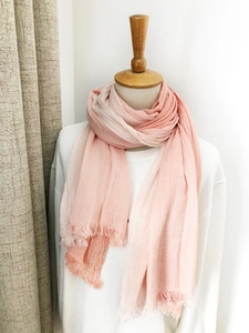 Detail shot of a pink gradient striped scarf with fringes on a female mannequin