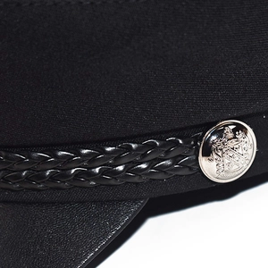 Chic black baker boy hat with woven faux leather strap and silver metal button detail