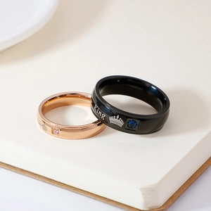 Crown-themed stainless steel couple rings with King lettering and cubic zirconia accents