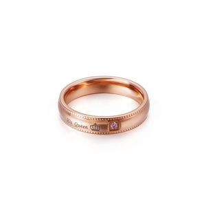 Rose gold crown ring with pink zircon and His Queen engraving on white background