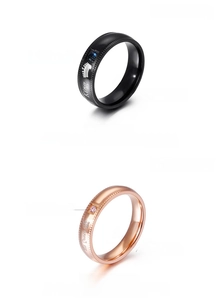 Detail of King and Queen stainless steel crown rings with sparkling crystal inlay