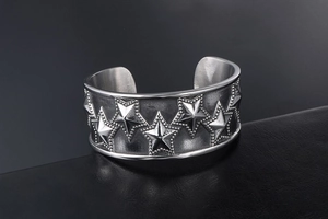 Macro shot of punk style stainless steel cuff bracelet with embossed star patterns