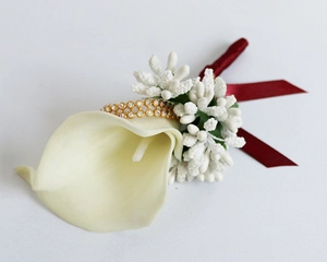 Detail of white PU calla lily boutonniere with gold diamond trim and burgundy ribbon