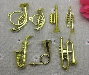 Detailed view of DIY golden musical instrument charms including saxophone and trumpet shapes