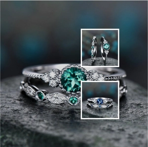 Macro detail of silver ring set with round green gemstone and marquise accents