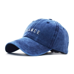 Detail of washed denim baseball cap featuring white Chance letter embroidery and vintage texture