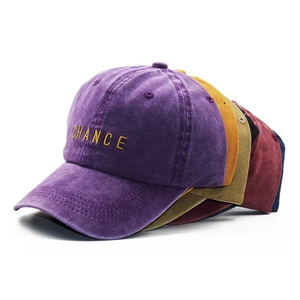 Detailed view of embroidery and washed cotton fabric on several vintage baseball caps