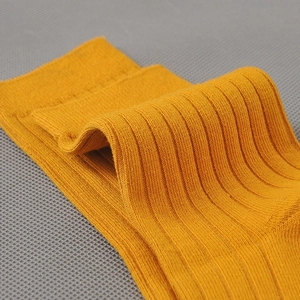 Close-up of yellow ribbed cotton business crew socks for men with elastic cuffs