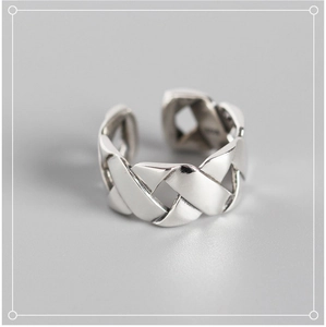 Macro shot of silver woven texture on S925 sterling silver wide cross ring band
