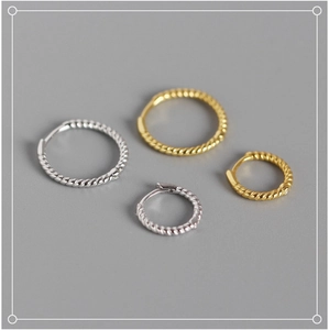 Close-up of gold and silver S925 sterling silver twisted rope hoop earrings set