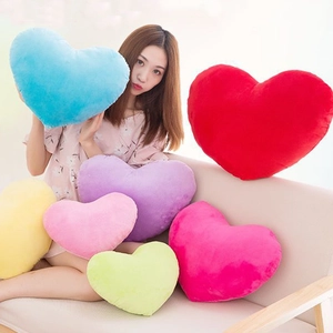Colorful heart-shaped plush pillows in various sizes and colors for home decor