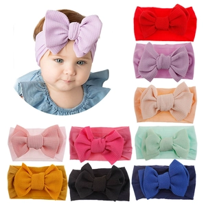 Set of 10 soft nylon baby headbands with large textured waffle knit bows in various colors