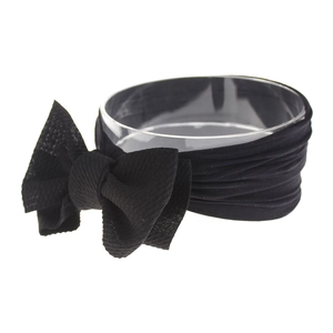 Close-up of black knotted nylon baby headband with a soft elastic textured bow