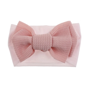 Detailed view of pink waffle texture bow on soft nylon elastic headband for baby girls