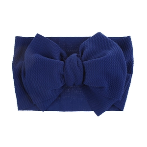 Detailed close-up showing the navy blue waffle knit texture of this baby bow headband