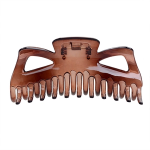Detailed view of amber hollow large hair claw clip with strong metal spring