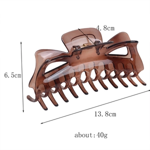 Macro shot showing dimensions 13.8cm of brown hair claw clip with metal spring detail