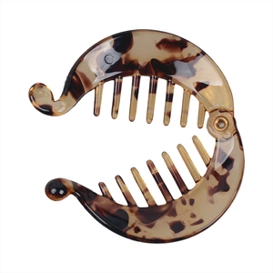 Macro shot of brown tortoiseshell pattern banana hair clip with internal teeth grip