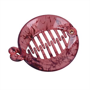 Macro detail of wine red banana hair clip with marble texture and inner comb teeth