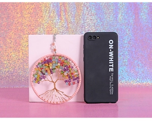 Macro shot of handmade Tree of Life wall hanging with colorful crystal stone beads