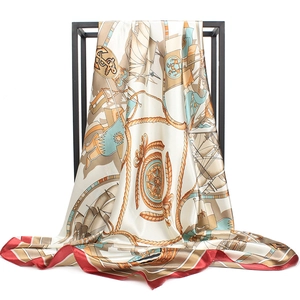 Detailed close-up of silk-feel square scarf featuring nautical anchor and compass patterns