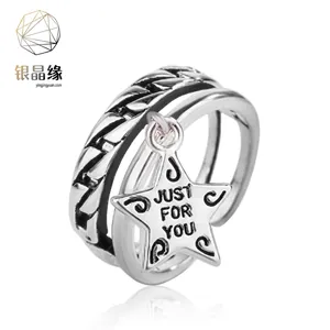 Detail showing rotating silver star charm with Just For You engraving on ring band