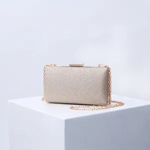 Elegant champagne gold glitter evening clutch bag with metallic chain strap and hard shell