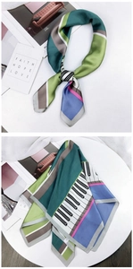 Detailed view of artistic silk square scarf with piano key patterns and geometric colors