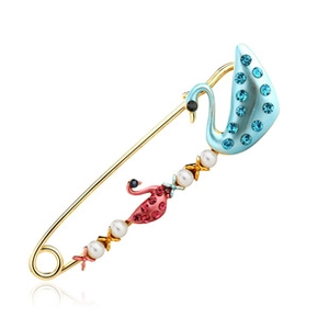 Detail of swan brooch featuring blue and pink enamel with rhinestones and white pearls