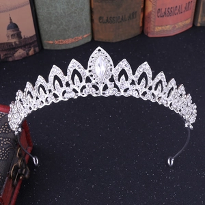 Macro detail of leaf alloy bridal crown with white rhinestones on black background