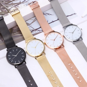 Detailed view of minimalist quartz watches with mesh straps in four classic metallic colors