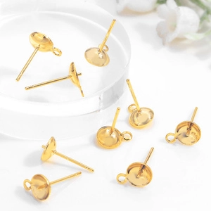 Macro detail of golden metal DIY earring studs with bowl base and needle for jewelry making