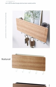 Close-up of wooden wall organizer with five hooks and a storage slot for keys and mail