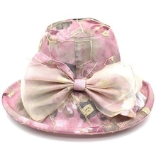 Detail of pink floral sun hat featuring a large translucent decorative bow on top