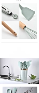 Close-up of mint green silicone kitchen tools with wooden handles and storage bucket