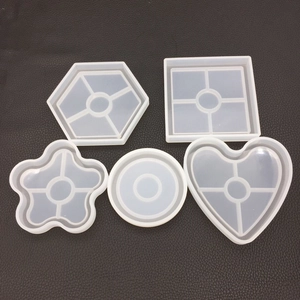 Detailed view of 5 silicone resin molds including heart and flower shapes on leather